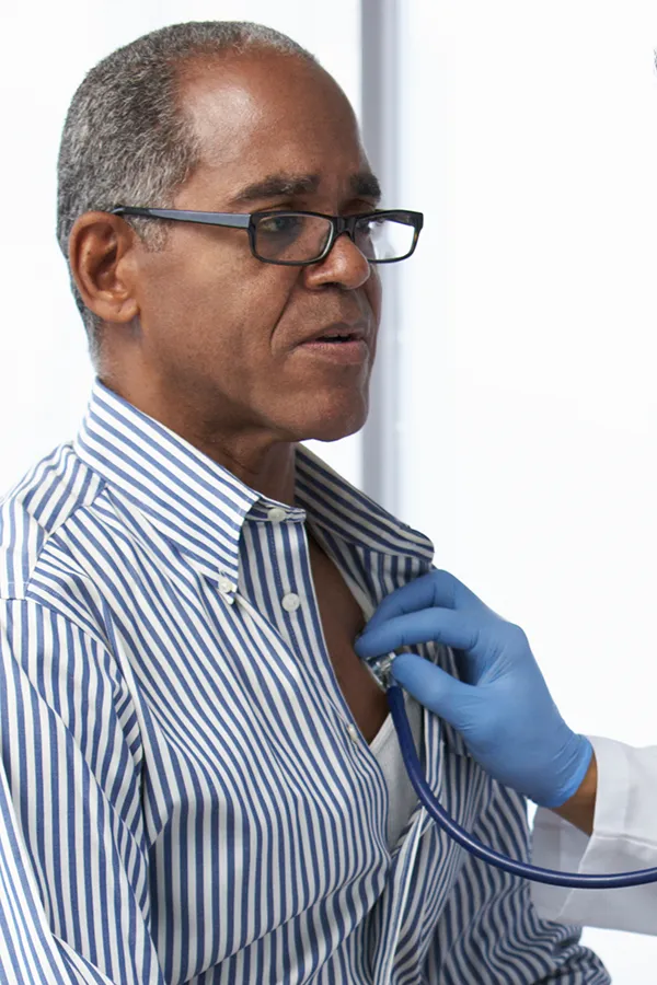 Cardiovasuclar-and-Lipid-Assessment-Treatment An older Black man gets his heartbeat checked. Get cardiovascular and lipid assessment from Morgan Burns, APRN in Central Florida.