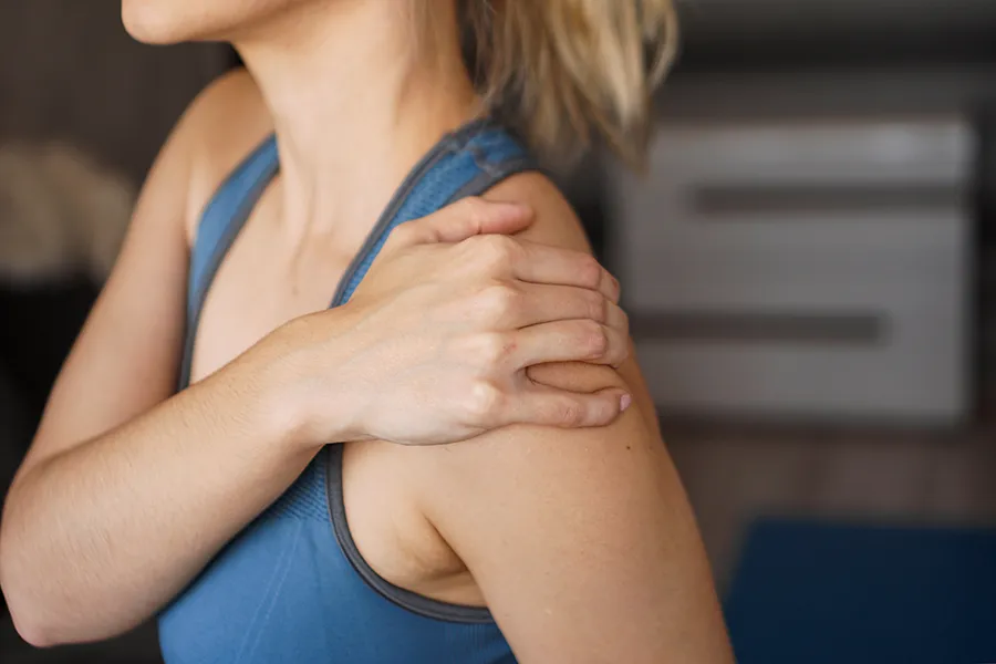 Chronic-Inflammation-Clinic A woman massages her sore shoulder. Get chronic inflammation treatment from Morgan Burns, APRN in Central Florida.