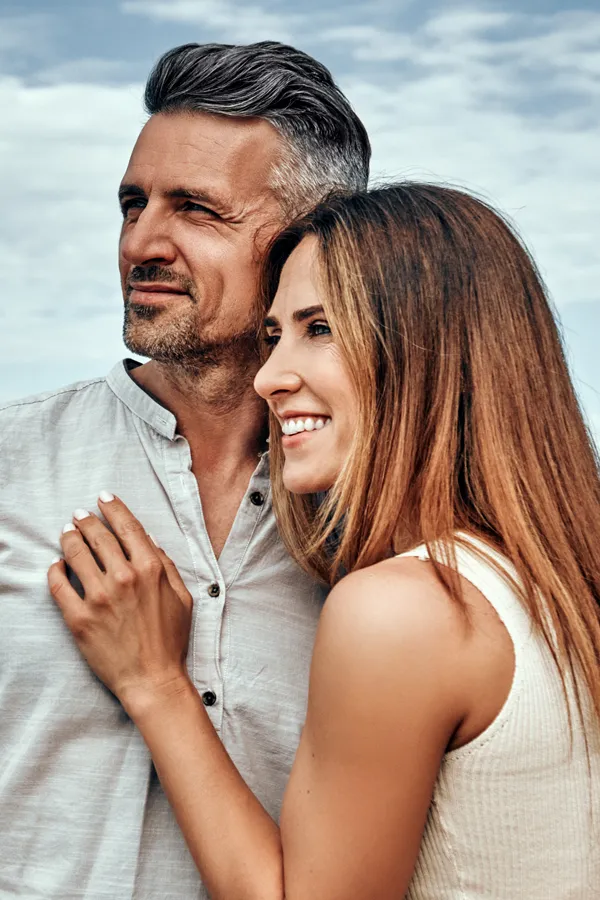 DNA-and-Genetic-Testing-Treatment A middle-aged couple smile as they look to the horizon. Get DNA and genetic testing from Morgan Burns, APRN in Central Florida.