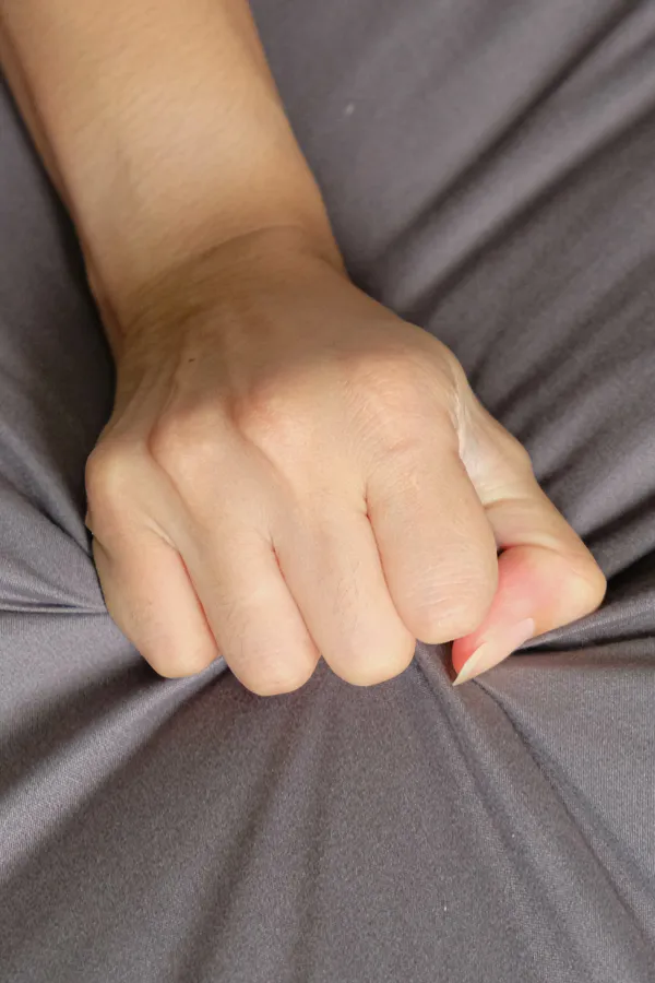 Female-Sexual-Dysfunction-Treatment Close-up of a woman's hand grabbing a sheet, indicating sexual pleasure. Get female sexual dysfunction treatment from Morgan Burns, APRN in Central Florida.