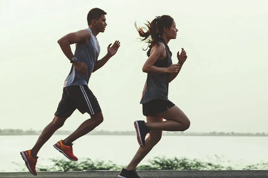 GLP-1-Weight-Loss-Injections-Clinic A couple in profile running along the water. Schedule GLP-1 Weight Loss Injections from Morgan Burns, APRN in Central Florida.