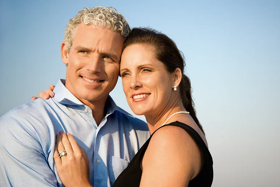 Healthy-Aging-Peptides-Doctor A middle-aged caucasian couple embraces in the sunshine, happy with the healthy aging peptide treatments from Morgan Burns, APRN in Central Florida