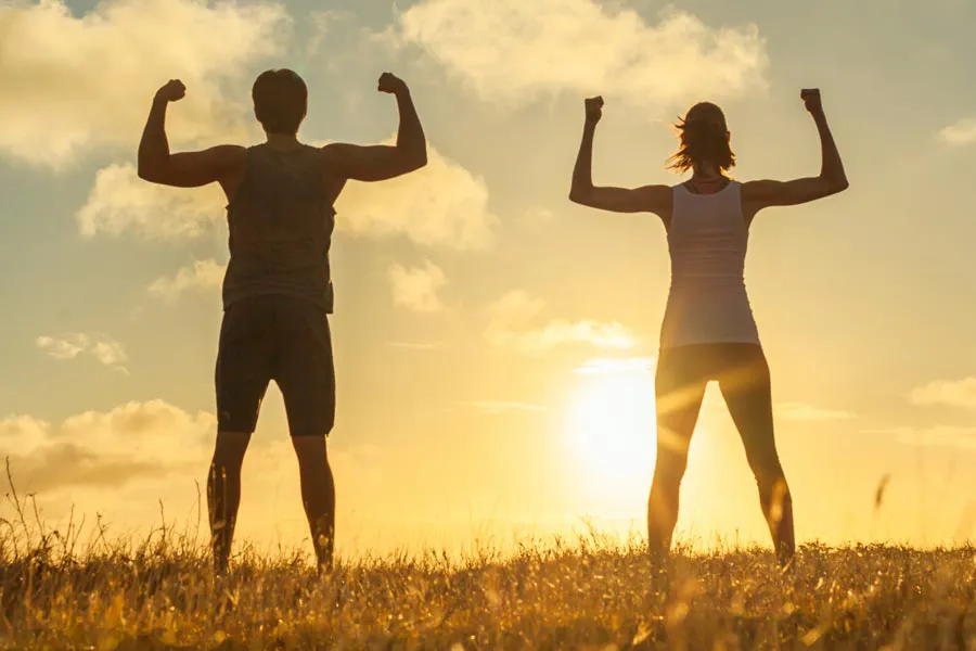 Immune-Optimization-Peptides-Clinic A couple flex their arms outside in the sunrise. Schedule Immune Optimization Peptide Treatment from Morgan Burns, APRN in Central Florida.