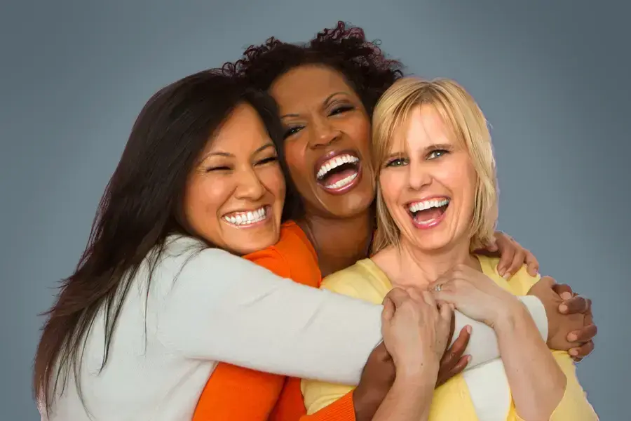 Insulin-Resistance-Clinic An asian, black, and white woman of middle age hug and laugh. Get insulin resistance treatment from Morgan Burns, APRN in Central Florida.