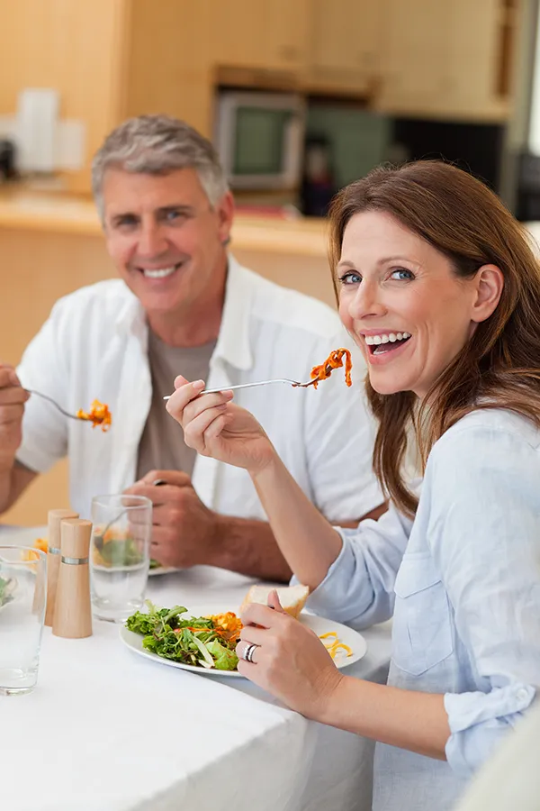 Leaky-Gut-Syndrome-Treatment Improve digestion with Morgan Burns, APRN's Functional Medicine for Leaky Gut Syndrome care in Central Florida, featuring a happy couple enjoying a nutritious lunch at home.