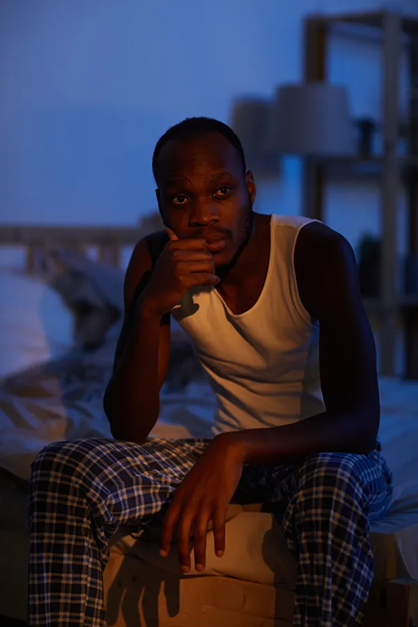 Sleep-Disorders-Treatment A man sits on the edge of his bed concerned that he can't sleep. Get treatment for sleep disorders from Morgan Burns, APRN in Central Florida.