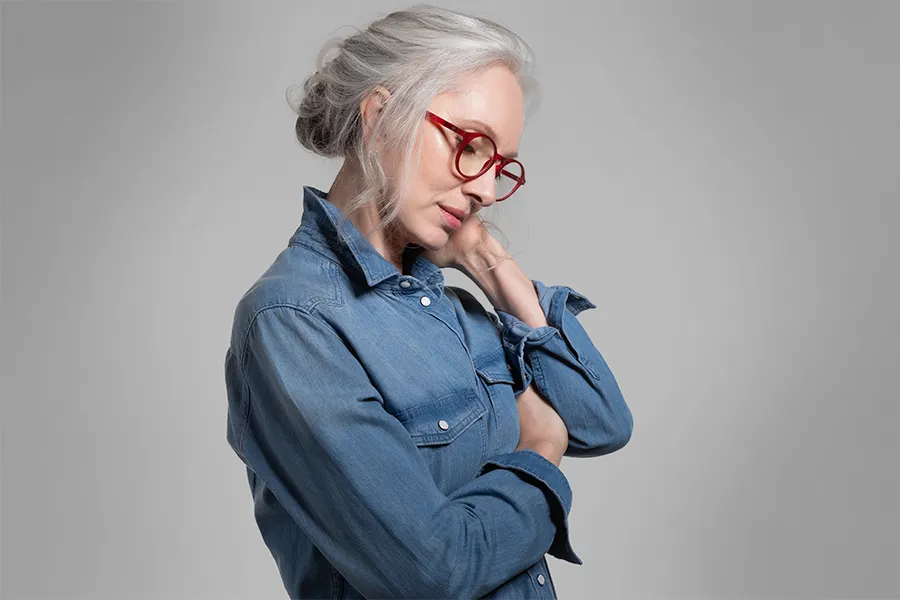 Stress-and-Burnout-Clinic A middle-aged woman rubs her neck from stress. Schedule treatment for stress and burnout from Morgan Burns, APRN in Central Florida.