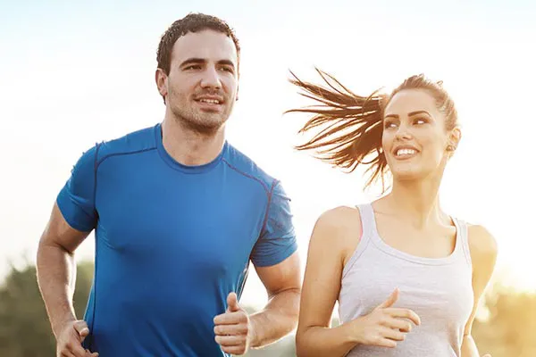 Weight-Loss-Resistance-Doctor A couple happily jogging in the sunlight after receiving effective weight loss resistance care from Morgan Burns, APRN in Central Florida.